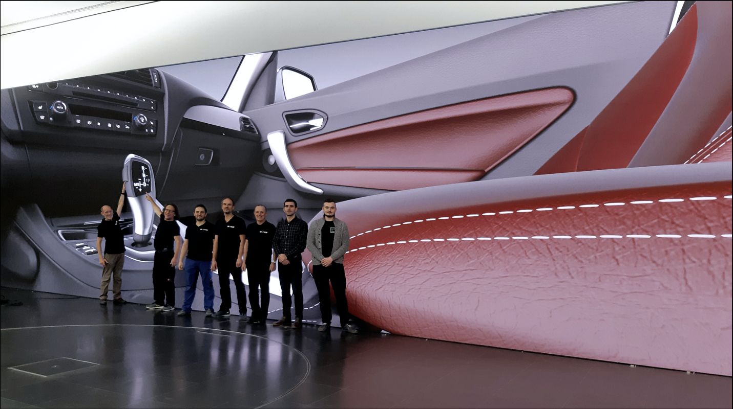 TRUE Performance engineers in front of a wall-sized dvLED display rendering a BMW interior at true color accuracy in an automotive design studio