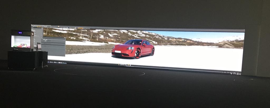 Porsche Taycan shown at life size on a TRUE dvLED design studio wall for color and surface review
