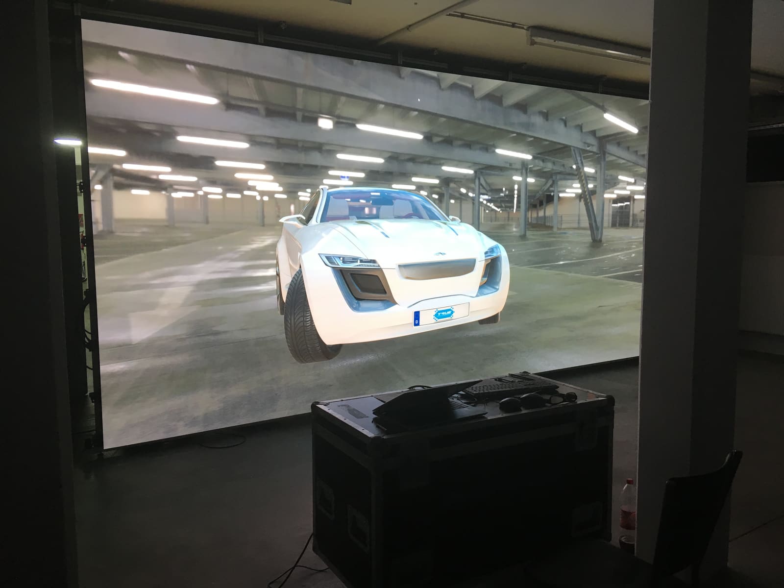 White concept car rendered at full scale on a TRUE dvLED design review wall