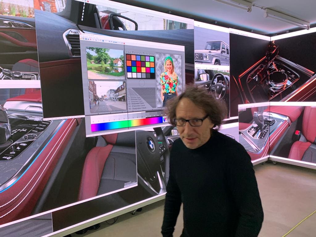 Automotive design studio with curved TRUE dvLED walls showing car interiors beside a colour reference chart