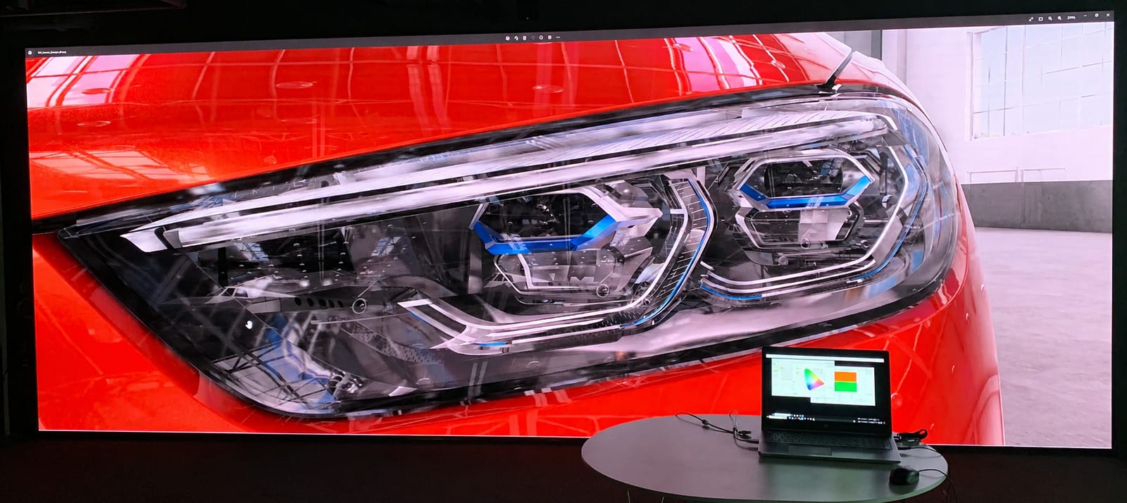 Car headlight close up on a TRUE dvLED wall with colorimetry measurement running alongside