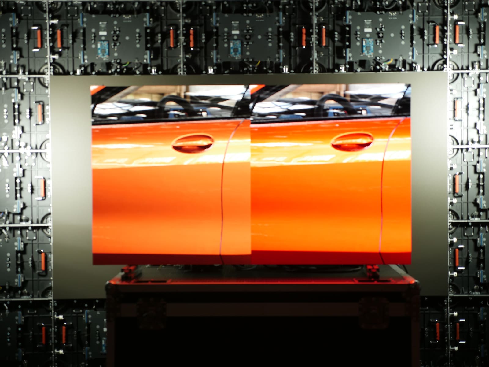 Orange car door shown side by side on TRUE dvLED for color comparison