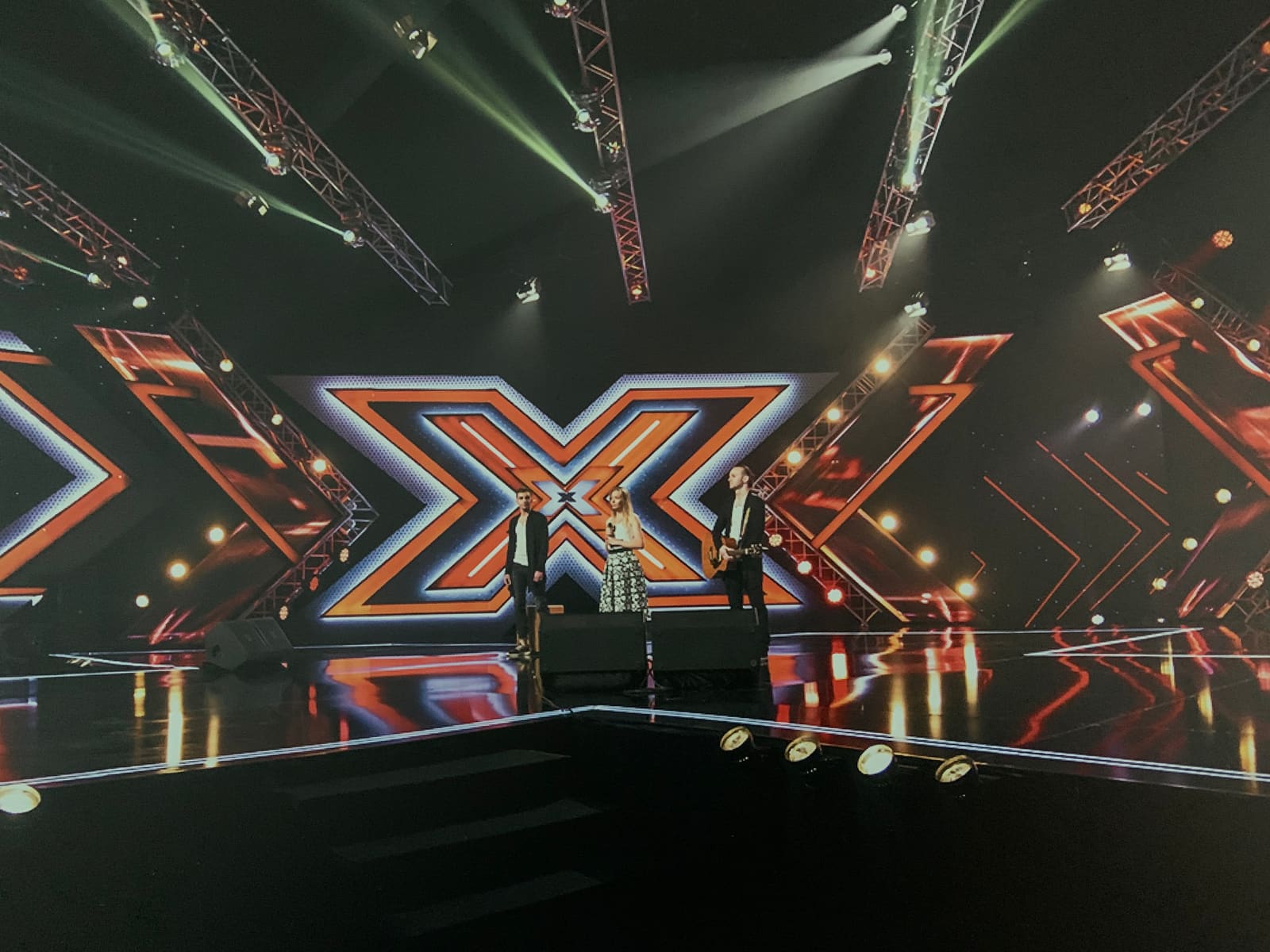 Talent show stage with a giant illuminated letter across a wraparound TRUE dvLED wall