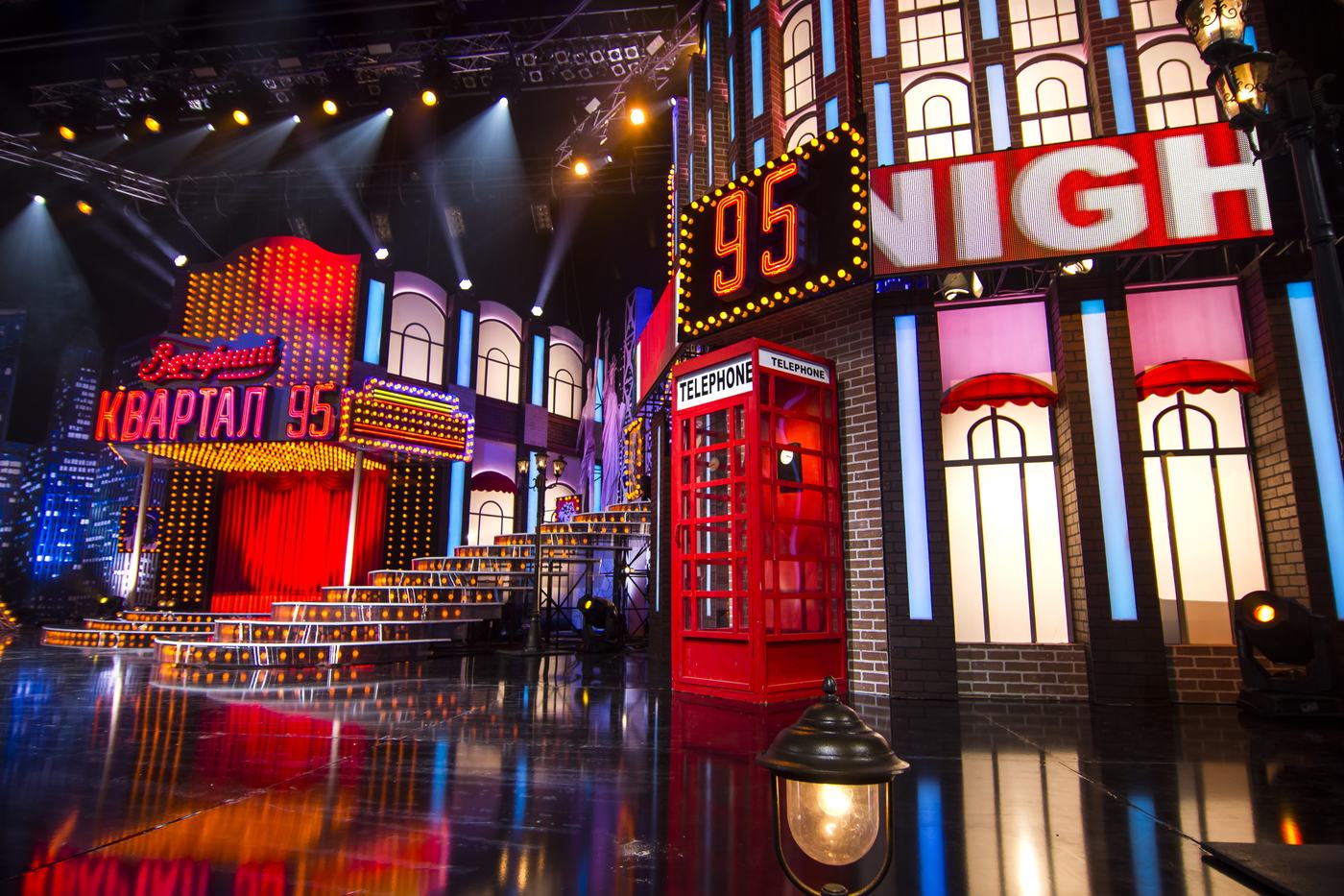Night street scene built from TRUE dvLED facades, neon marquee and a red phone box