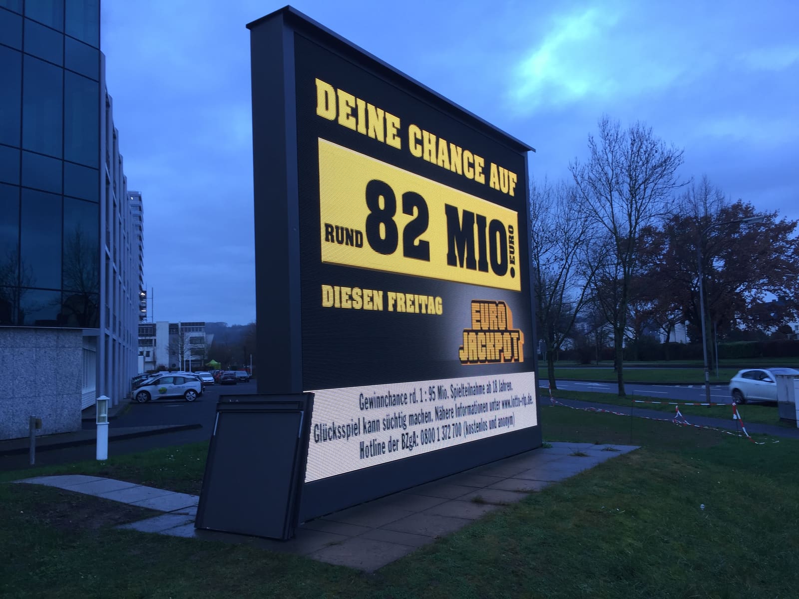 Low angle view of an outdoor TRUE dvLED totem showing Eurojackpot content at dusk