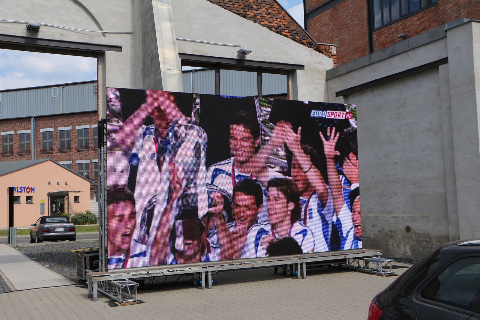 Mobile TRUE dvLED trailer screen showing live football in daylight