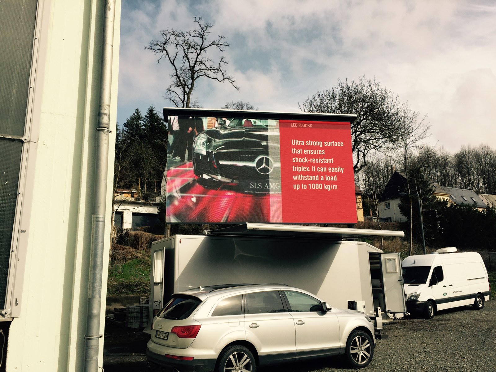 TRUE dvLED trailer screen raised on site next to a van