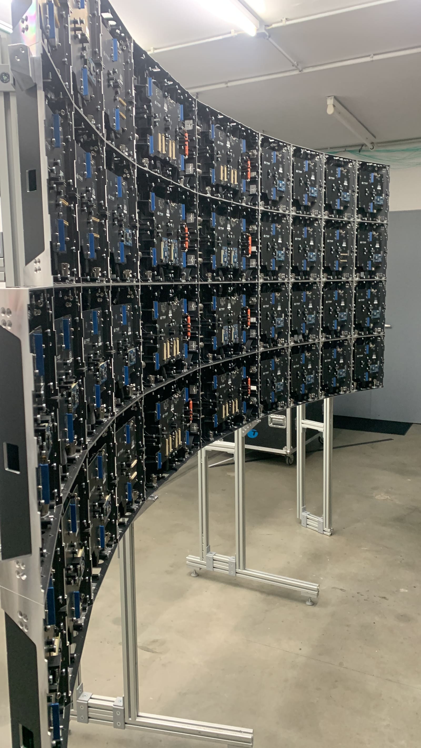 Rear of a curved TRUE dvLED wall showing receiving cards and panel internals