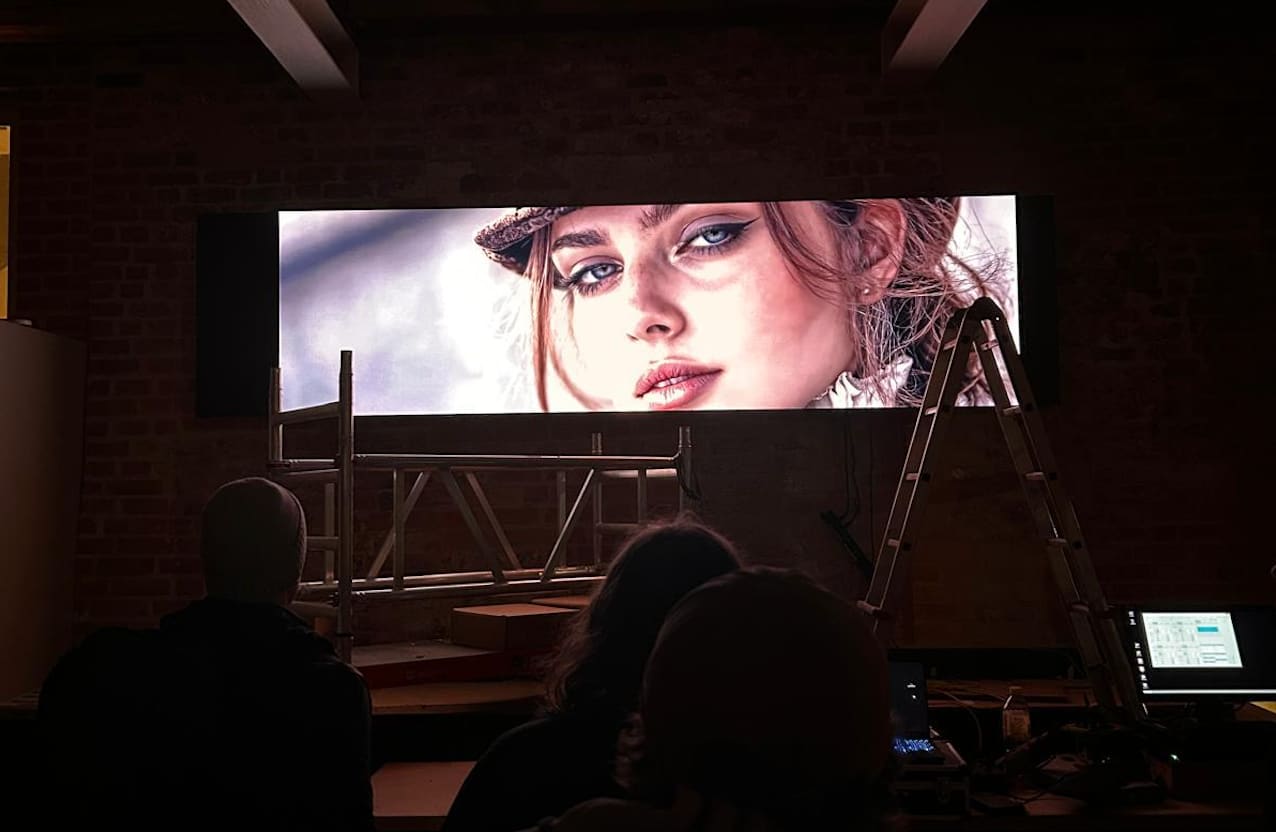 Panoramic TRUE dvLED wall in a brick loft studio in Lübeck with the crew reviewing the image
