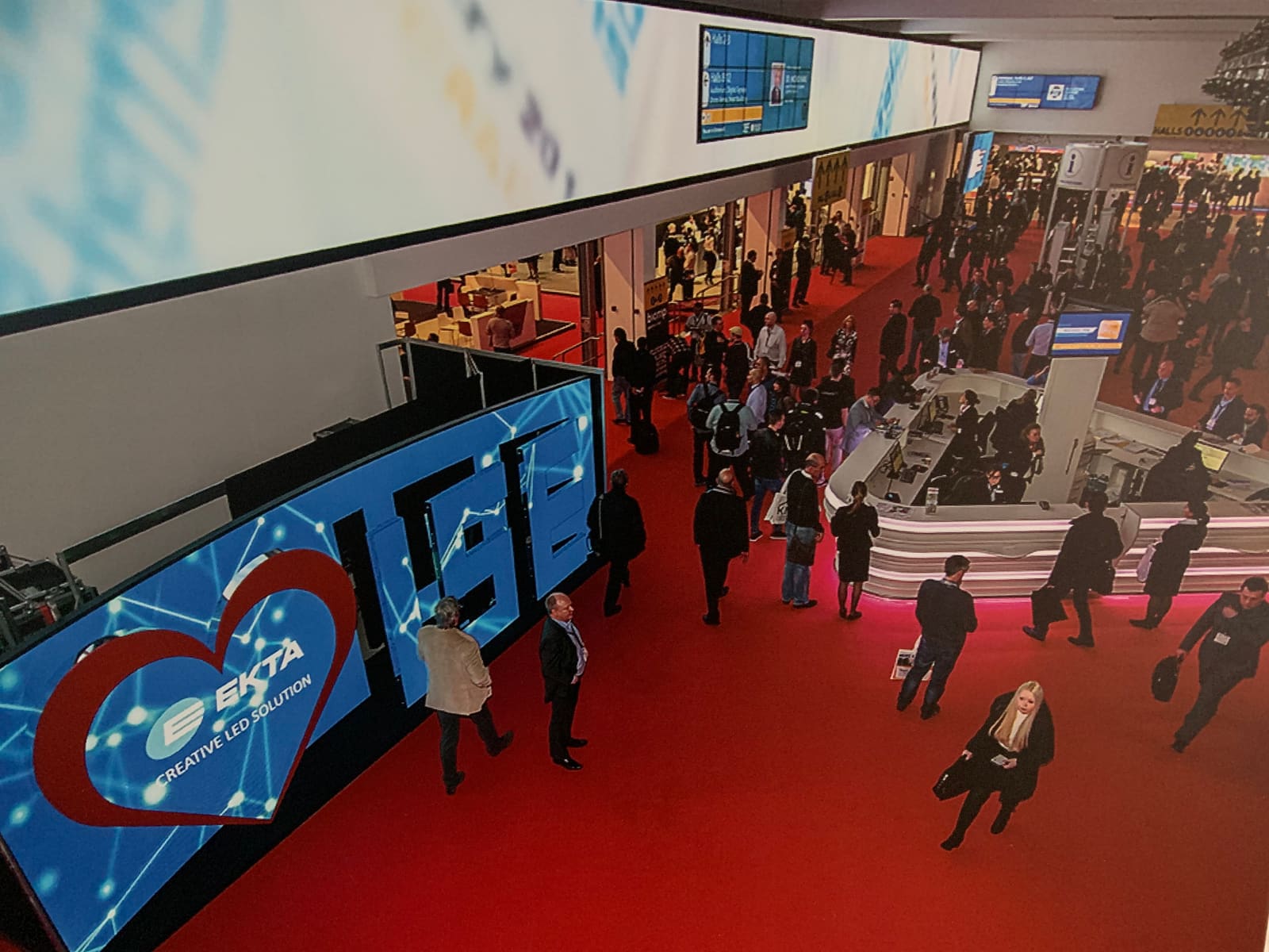 EKTA dvLED banner above the ISE trade show entrance with visitors arriving