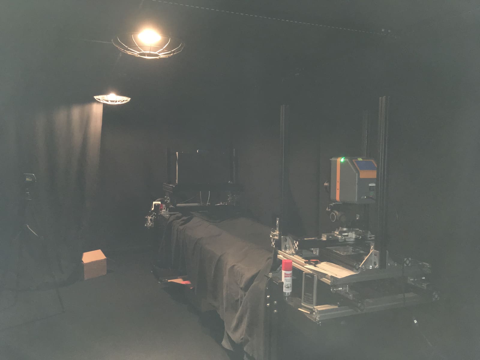 Colorimeter on a rail rig measuring a TRUE dvLED wall in the black walled measurement lab
