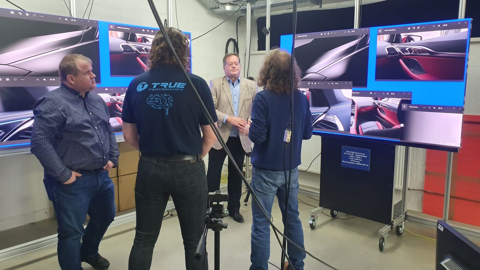 Group discussion in front of a TRUE dvLED wall showing car interior renders