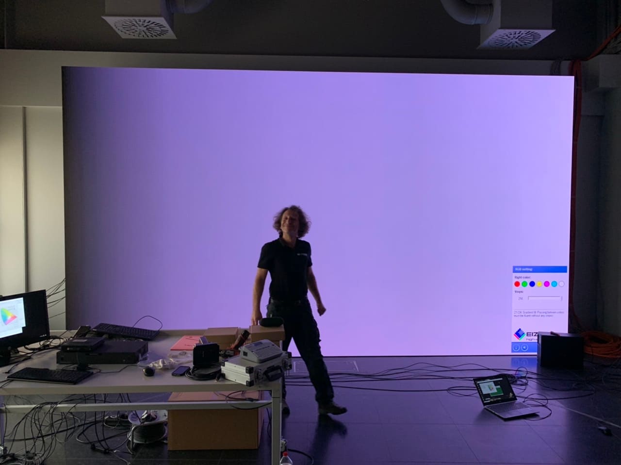 Technician in front of a large uniform field on a TRUE dvLED wall during a uniformity check
