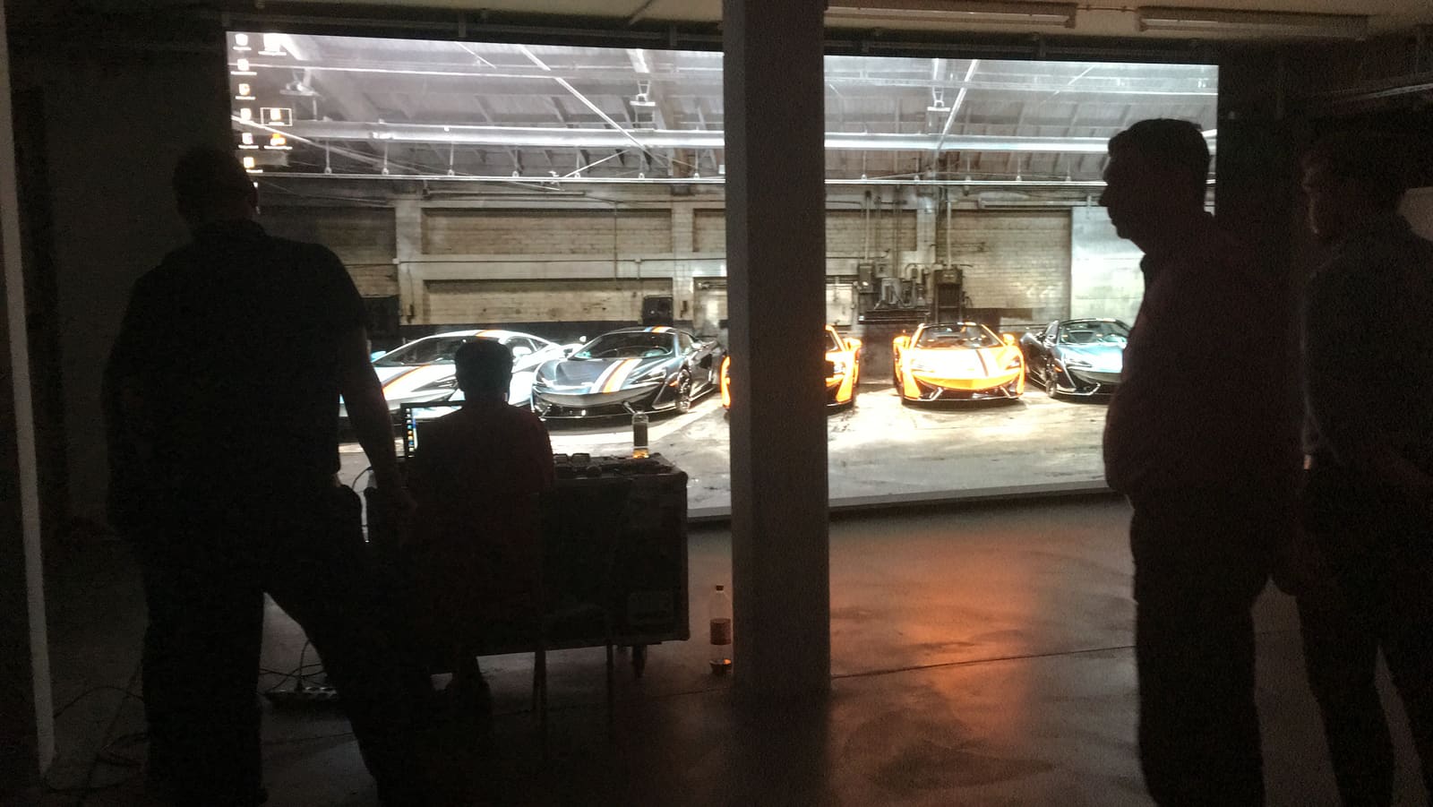 Visitors watching supercar footage on a large TRUE dvLED wall