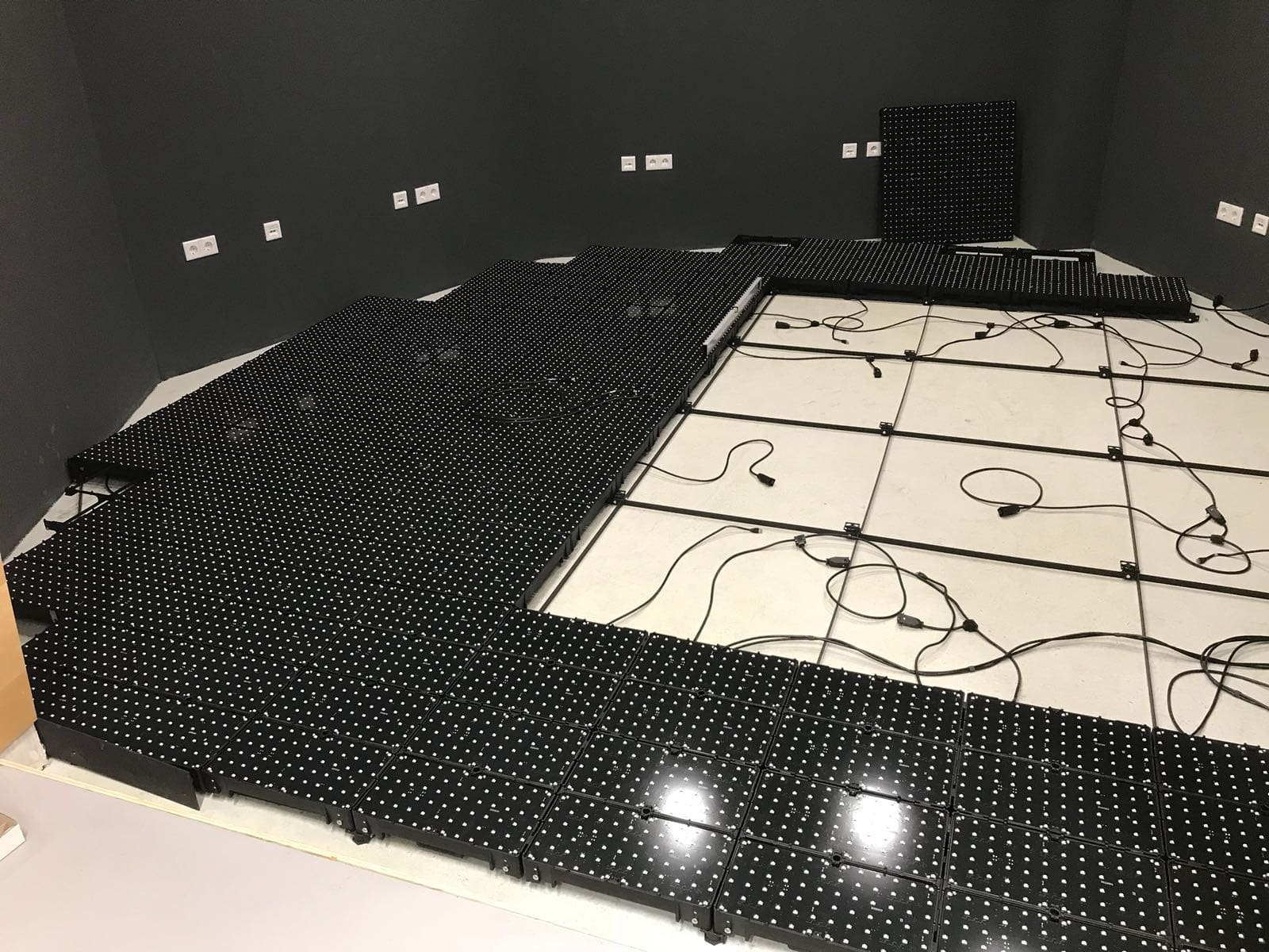 TRUE dvLED floor tiles being laid out with loop cabling during installation