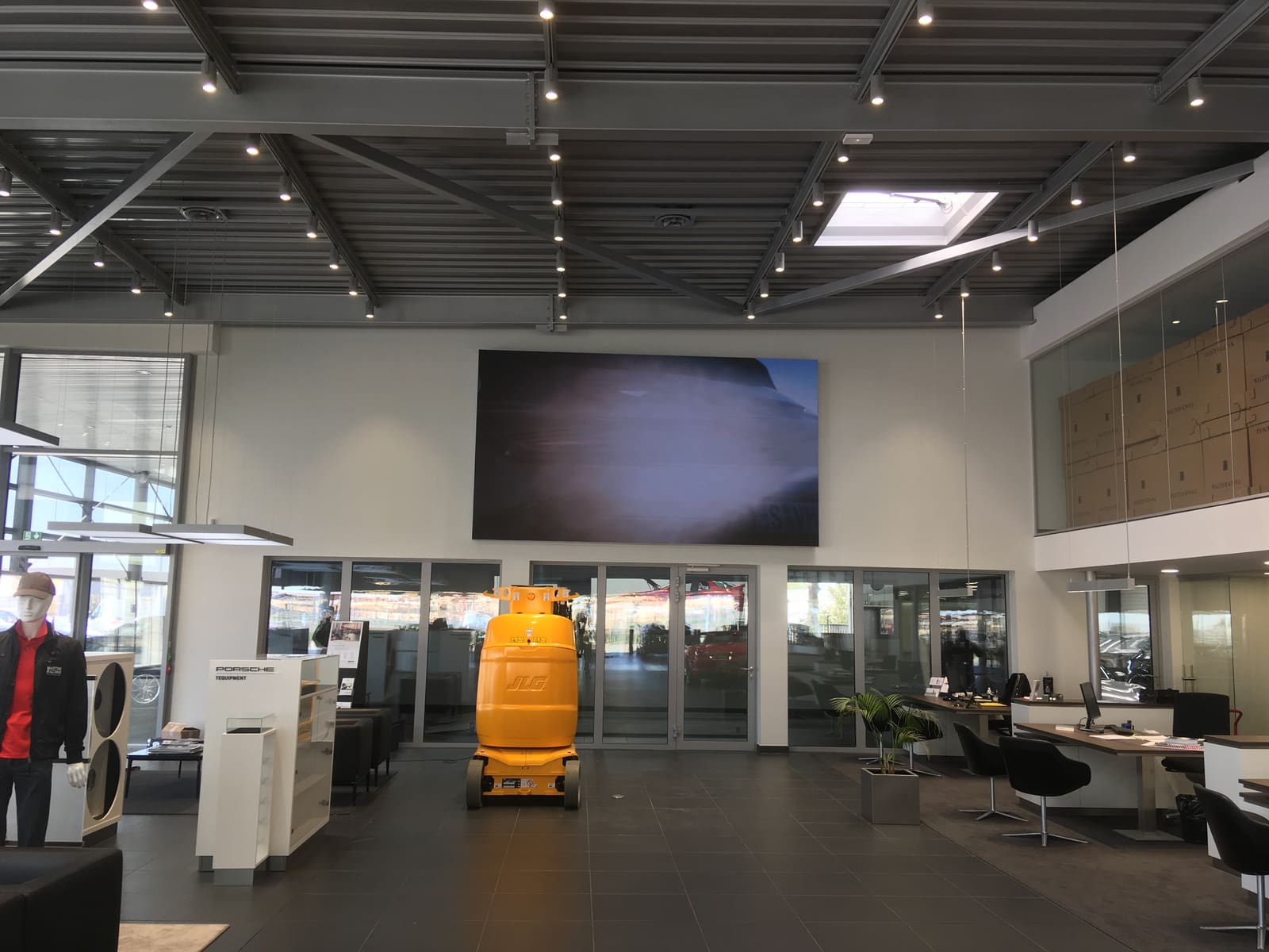 TRUE dvLED wall being installed in a car showroom from a lift platform