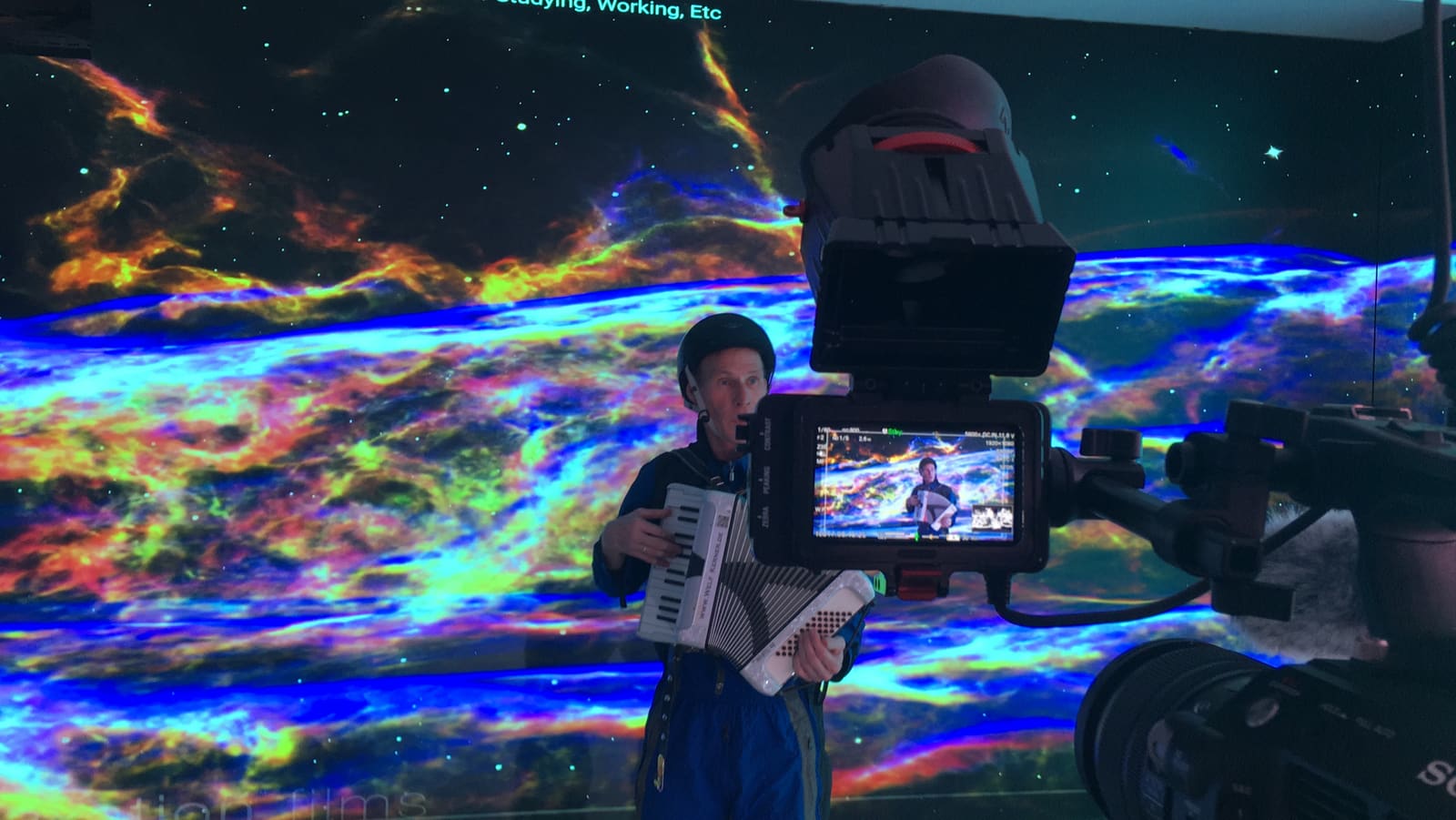 Cinema camera filming a performer against a nebula backdrop on a TRUE dvLED volume